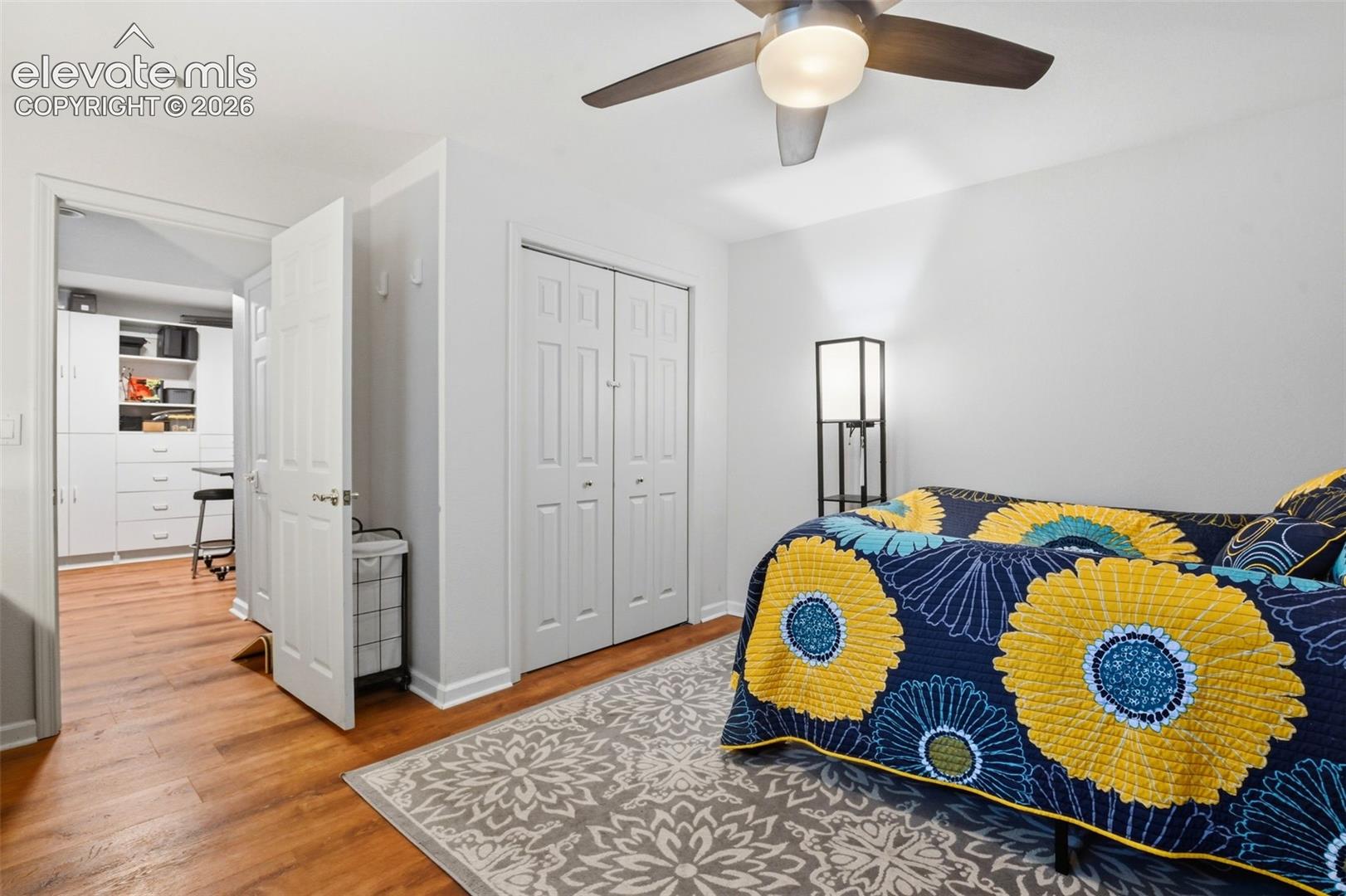 Basement Bedroom with newer flooring, ceiling fan and closet.