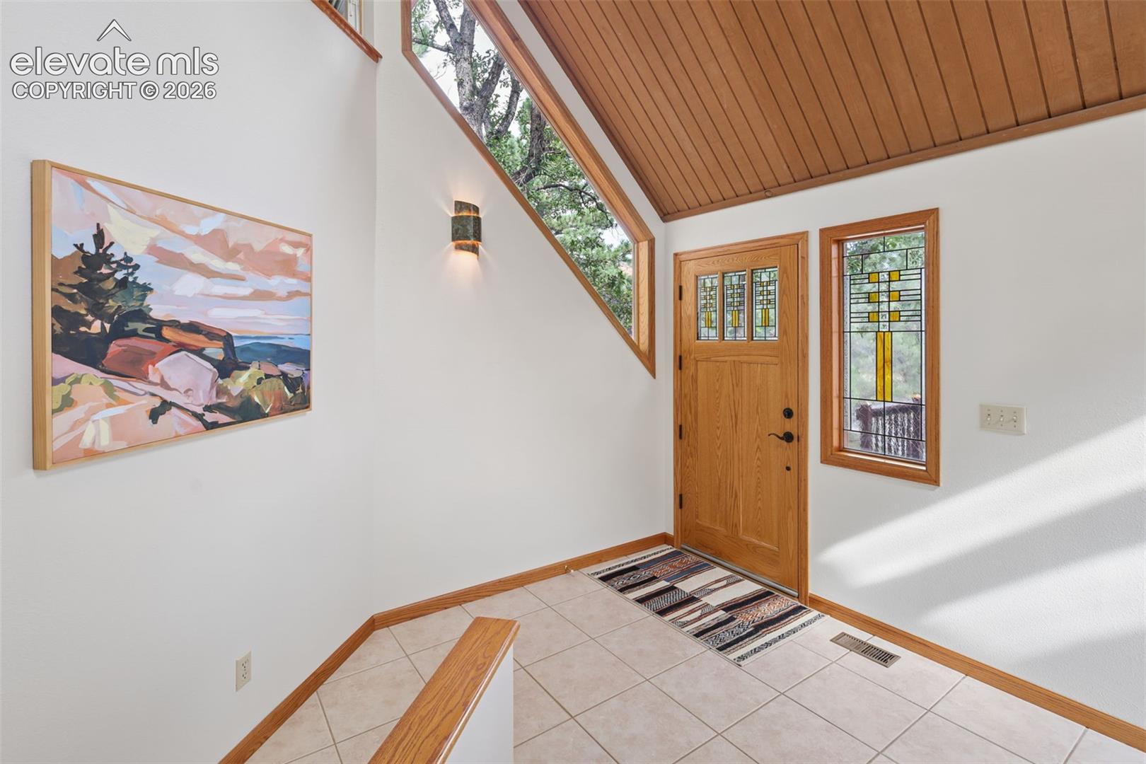 Inside you're greeted by a large entrance with a beautiful angled window to bring the outdoor scenery inside!