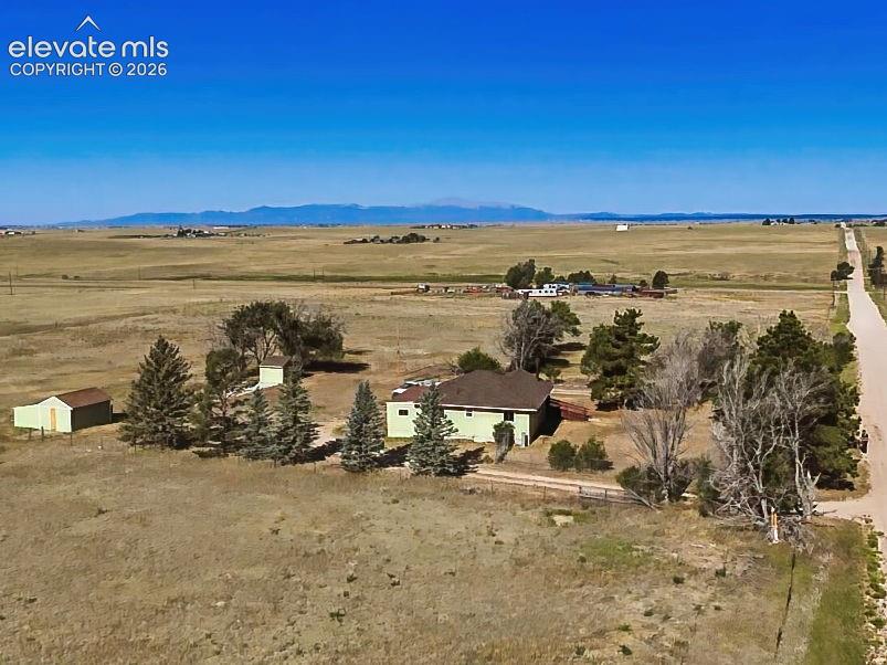 Property Aerial – Sweeping aerial perspective captures the property's generous footprint, outbuildings, and wide-open views of the surrounding countryside.