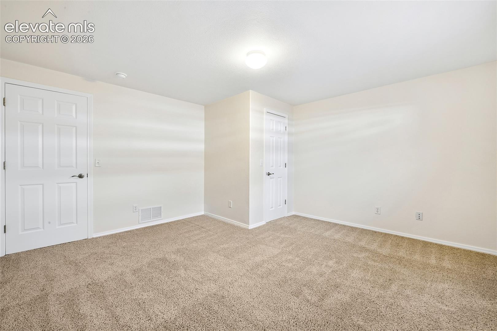 Basement Bedroom, Neutral toned walls with carpeting