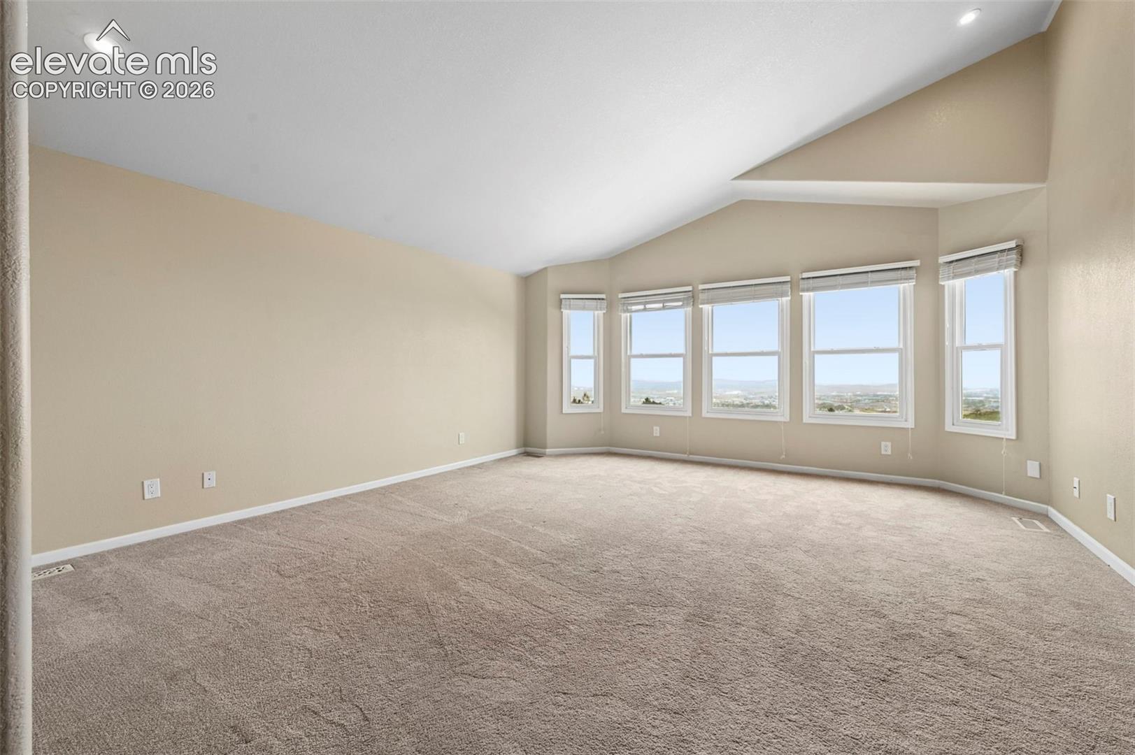 Unstaged primary bedroom overlooking the city!