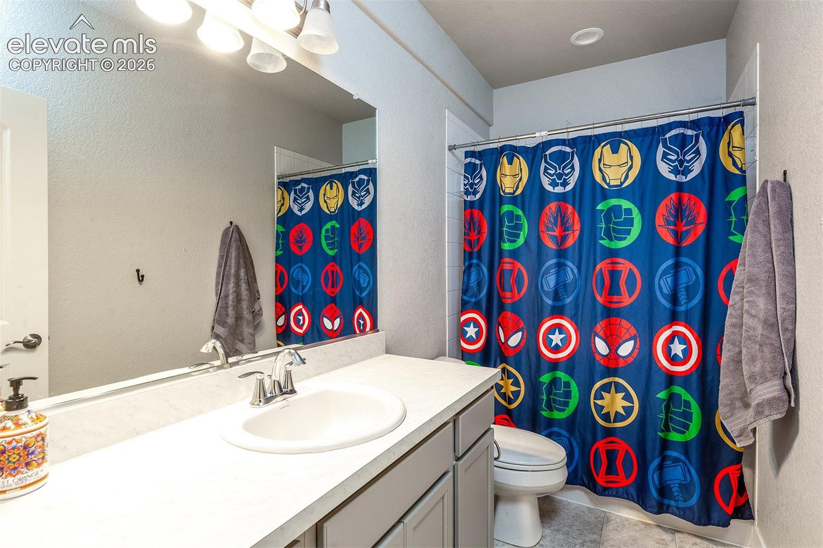Single vanity with integrated sink, chrome faucet, and expansive wall mirror