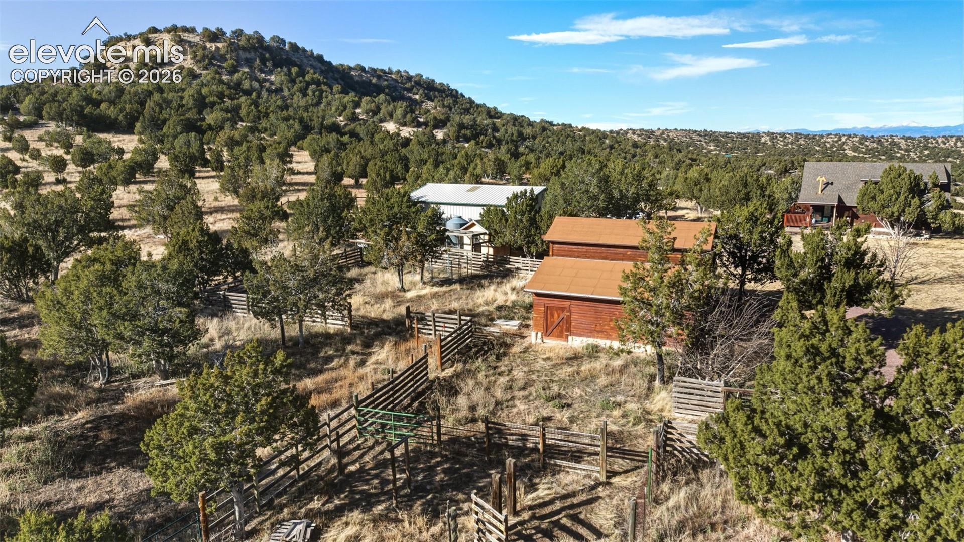 Expansive property featuring a rustic barn structure, a main residence, and a secondary structure