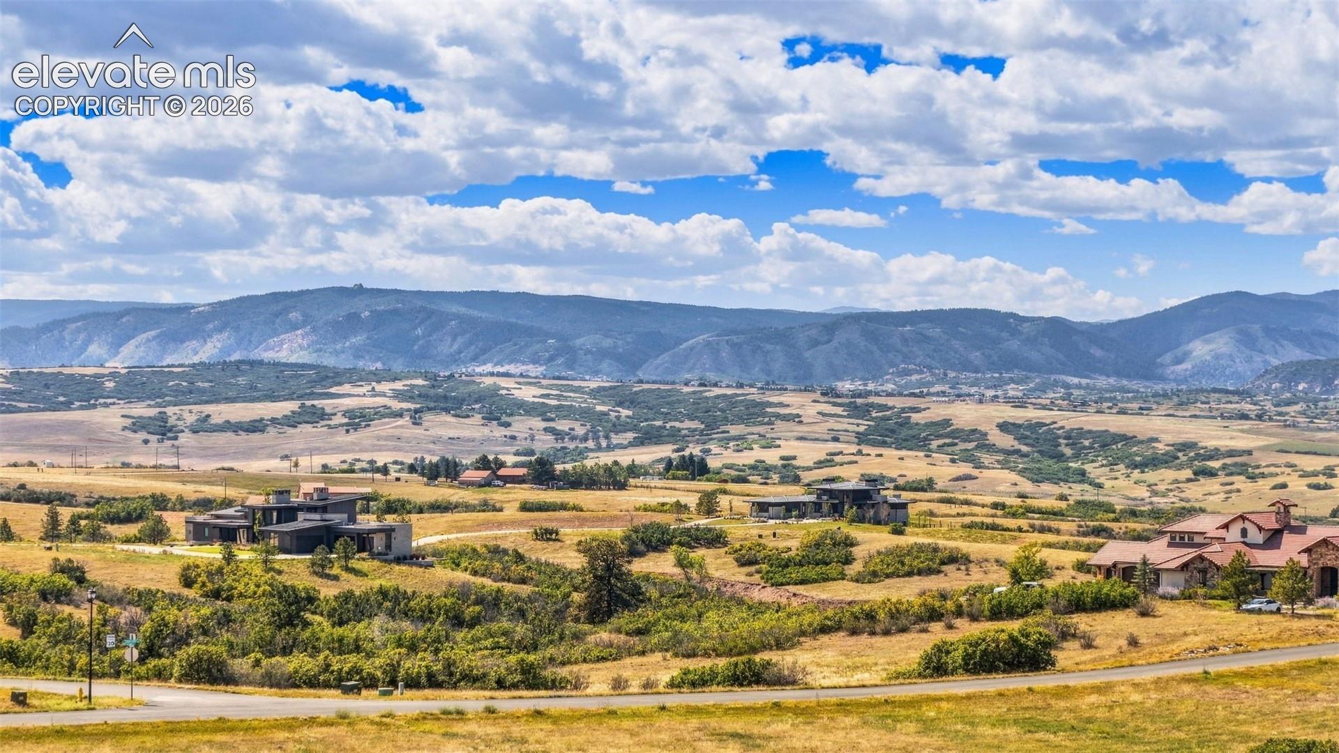 Expansive mountain landscape with scattered residential properties