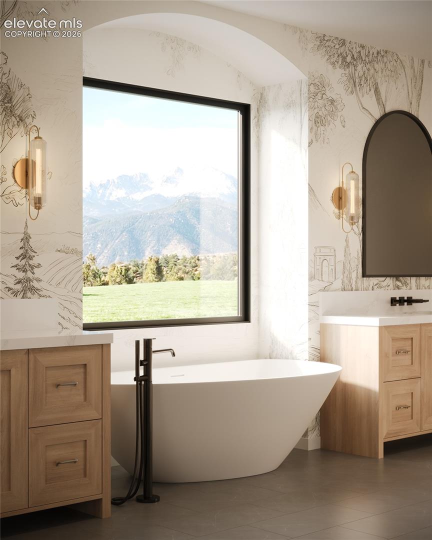 Arched alcove with a freestanding soaking tub, large picture window, and floor-mounted tub filler
