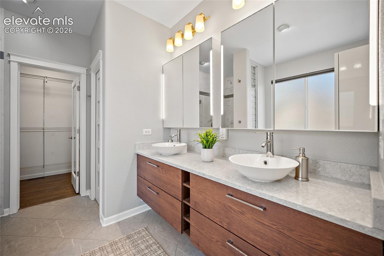 Primary bath has custom oversized dual medicine cabinets