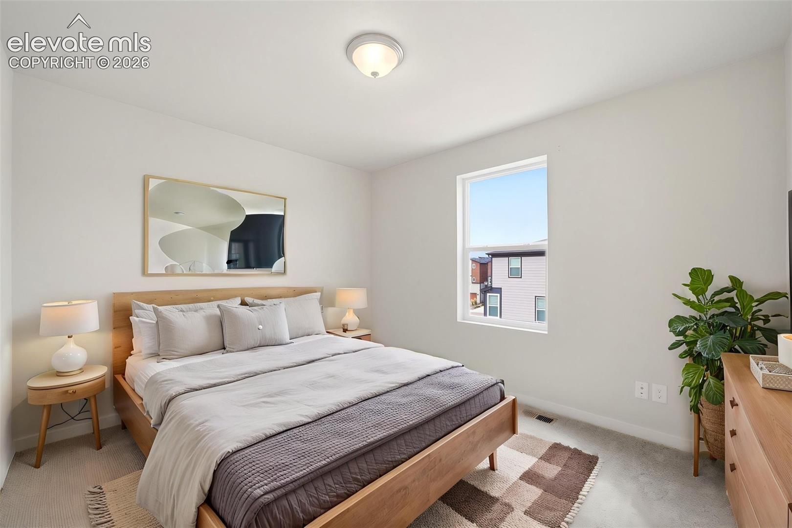 Bedroom -2 Neutral gray walls and light gray carpeting create a versatile interior palette
