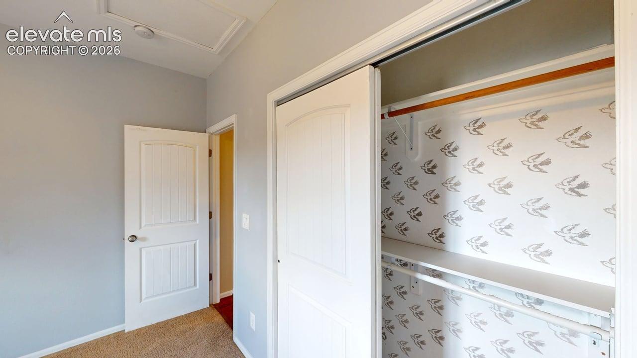 Sliding closet doors with interior shelving and a hanging rod