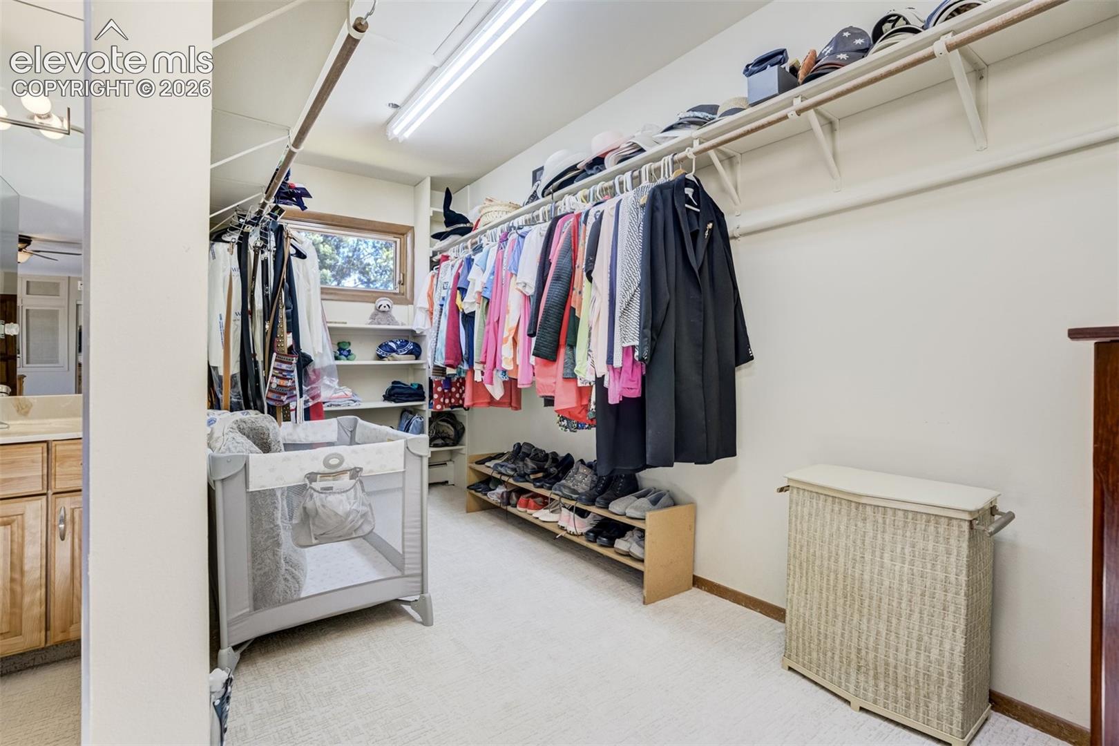 Walk in closet with a bright window in the primary bedroom
