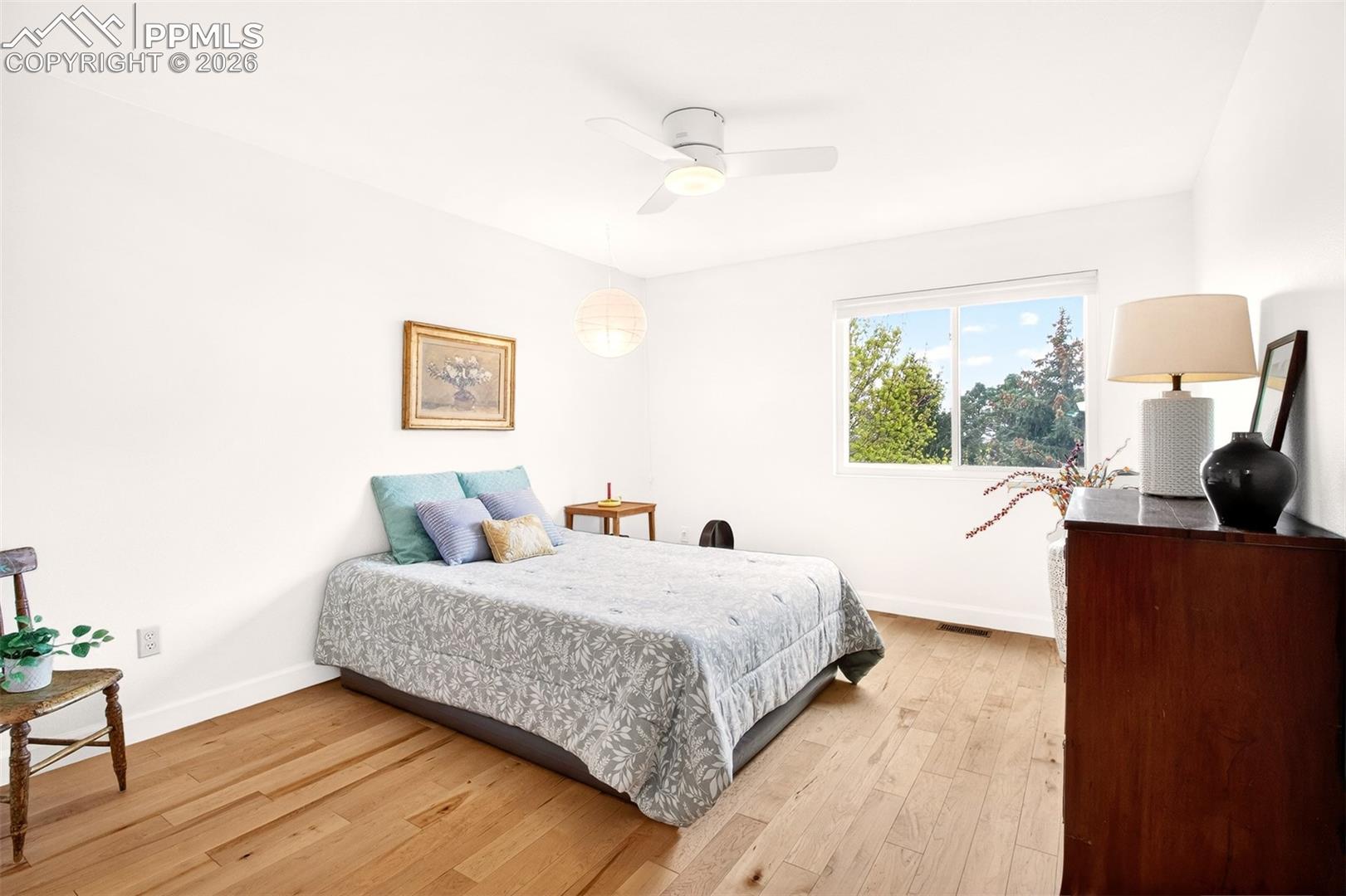 Upstairs second bedroom offers charming views from its window. 