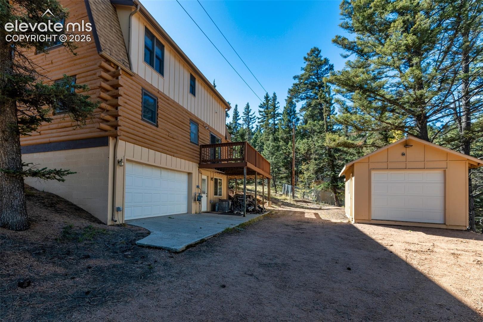 Garage on left and additional storage building on right