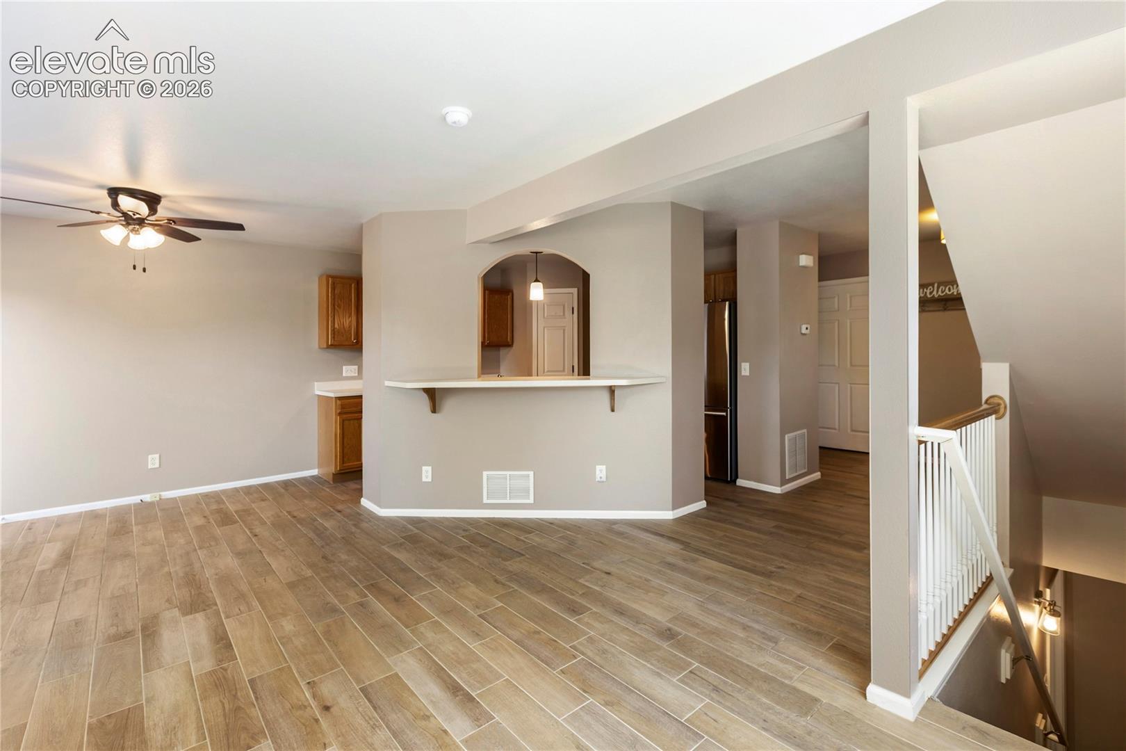 New floors and stacked stone on fireplace. Walks out to back deck-looking towards kitchen.