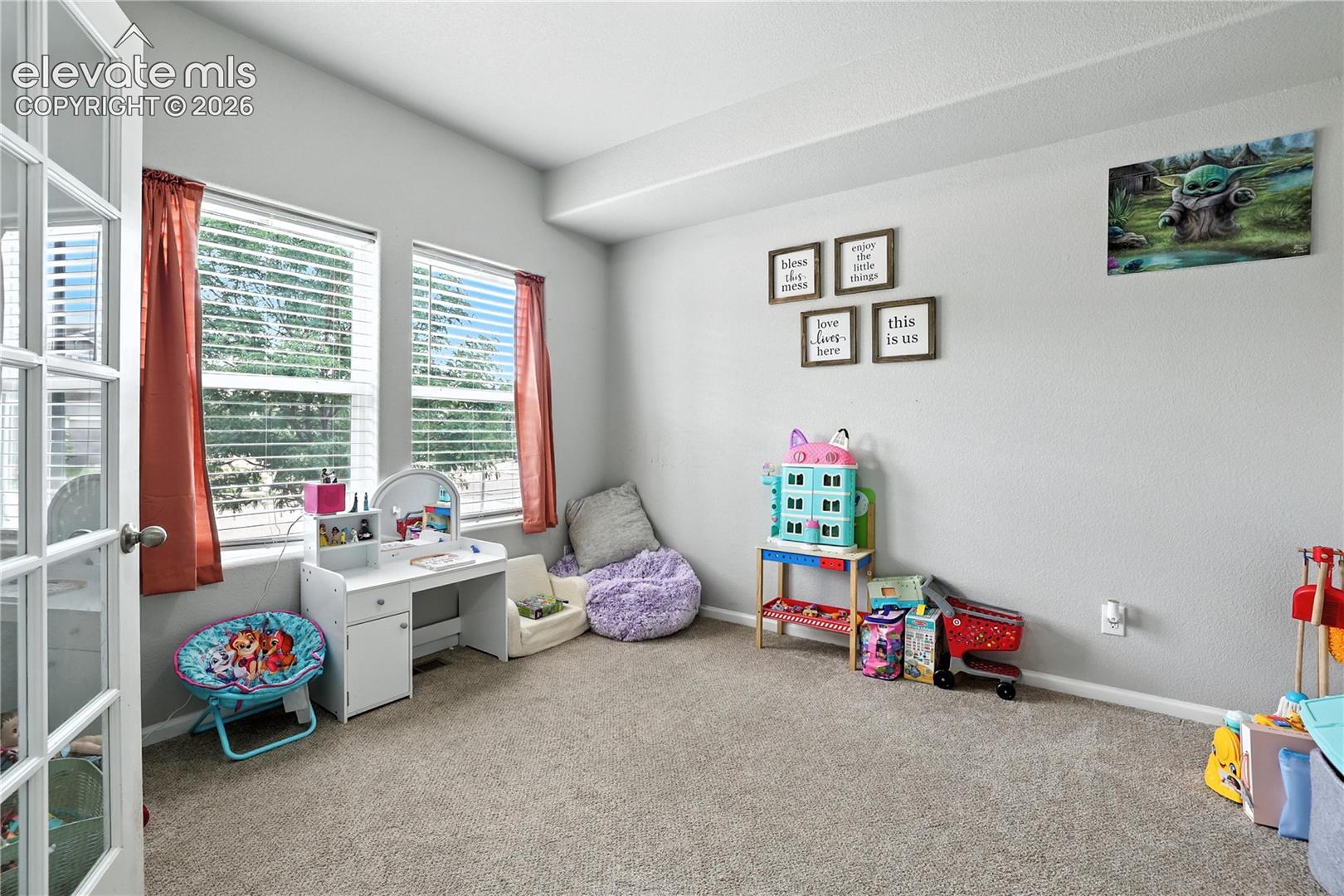 Recessed lighting, light gray wall finish, neutral tone carpet flooring, and white frame french doors