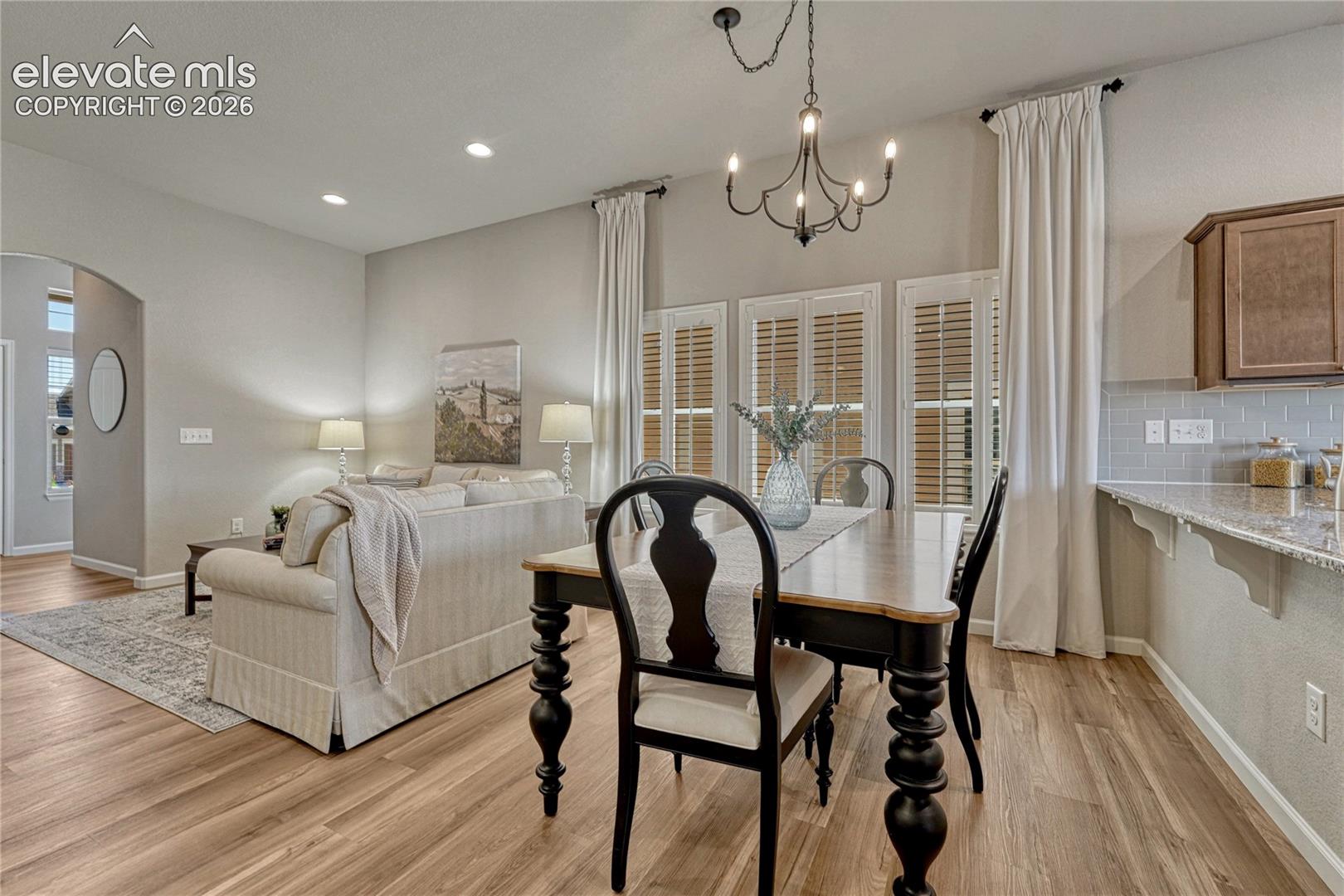 The dining space sits between the living room and kitchen breakfast bar.
