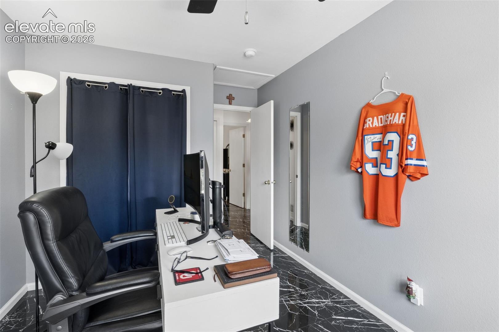 Black marble-finish flooring, light grey painted walls, white door frames, and a white ceiling