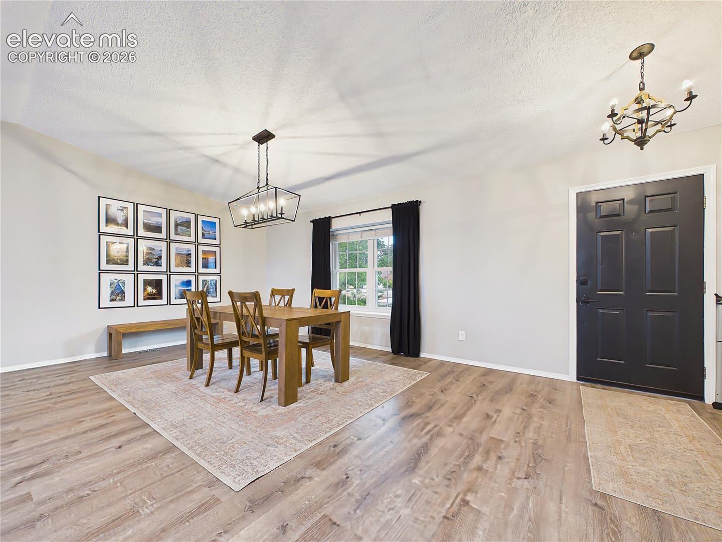 Inviting dining room filled with natural light from a large picture window, complemented by updated finishes and modern design details.