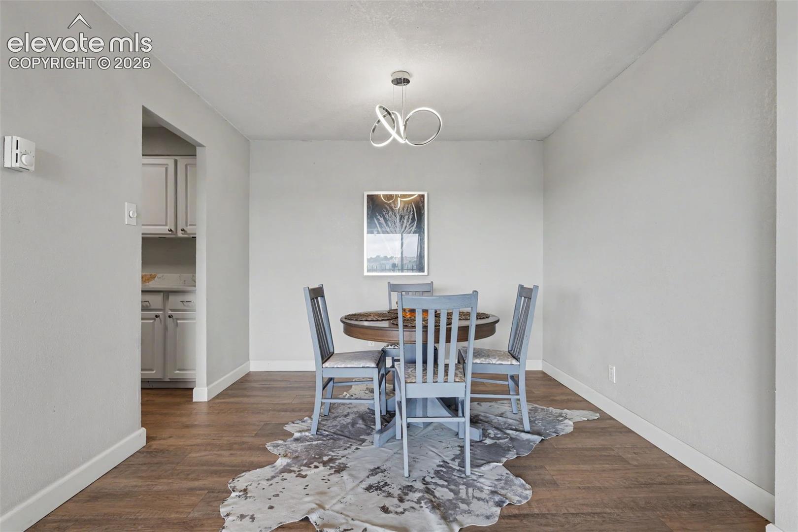 The dining area is situated off the Living Room and showcases an impressive LED light fixture!