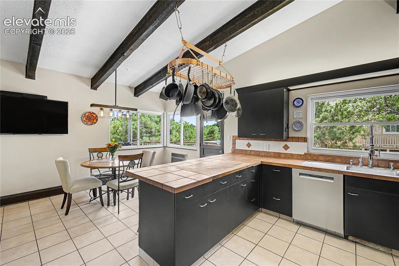 Your eye is  drawn straight through to the breakfast nook, reinforcing the home's effortless, connected layout.