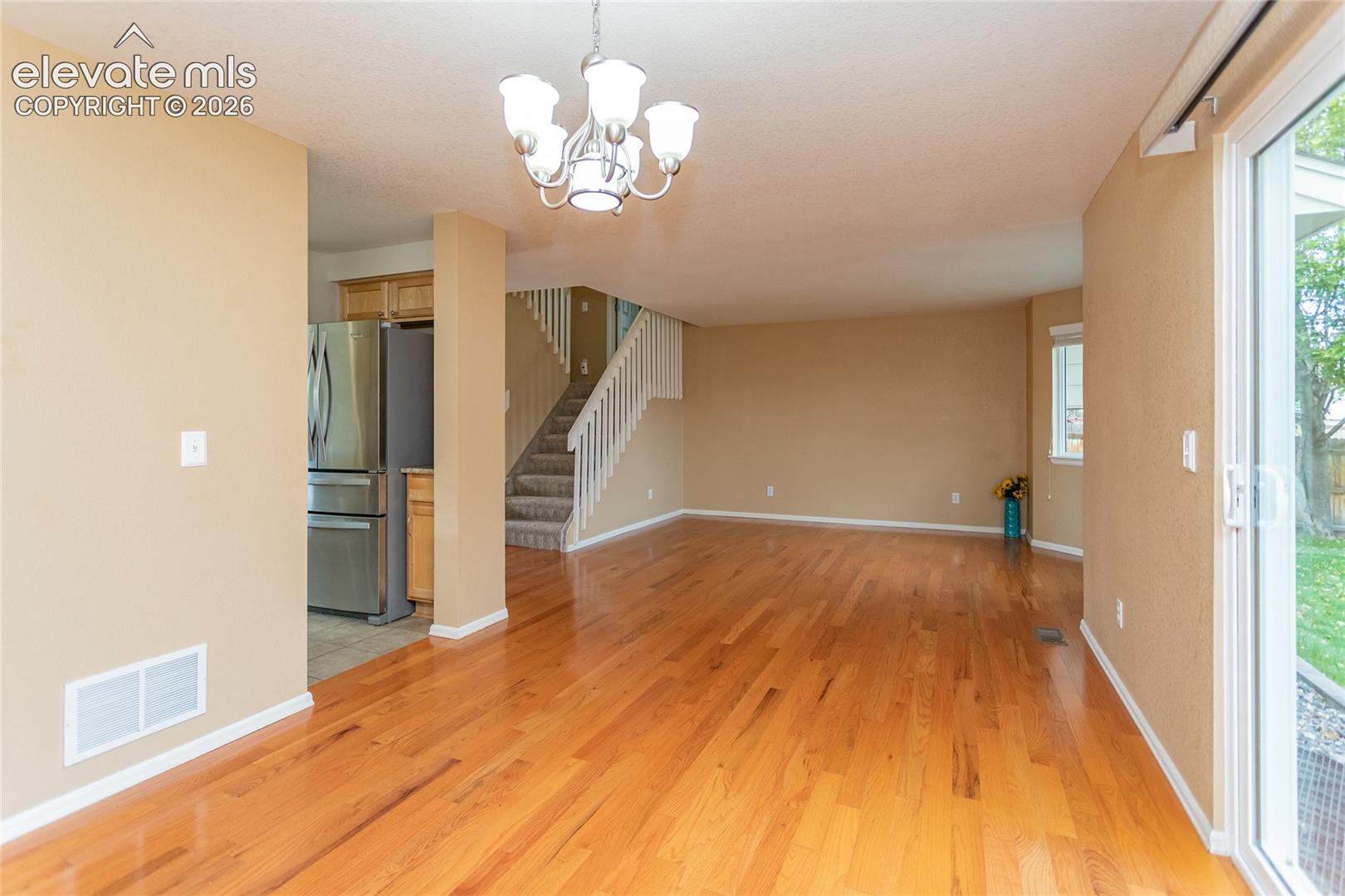 Dining room open to living room with oak hardwood floors