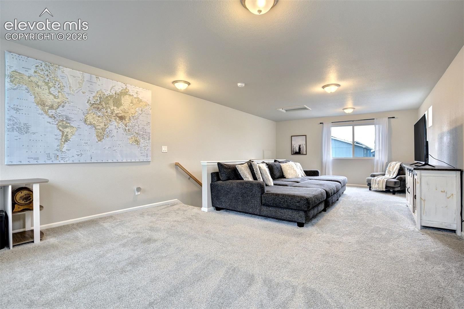 Expansive room featuring wall-to-wall carpeting, recessed lighting, and a single-pane window