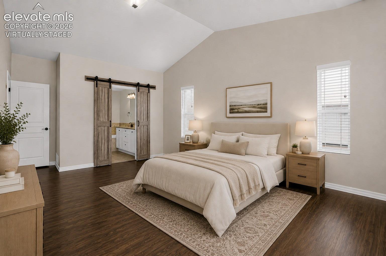 Virtually Staged - Vaulted ceiling, wood-finish flooring, and a pair of barn doors