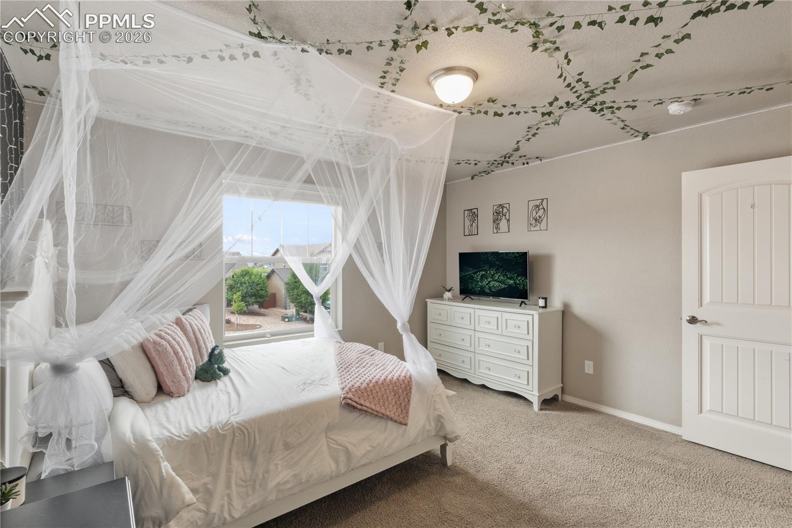 Bedroom with carpet floors and baseboards