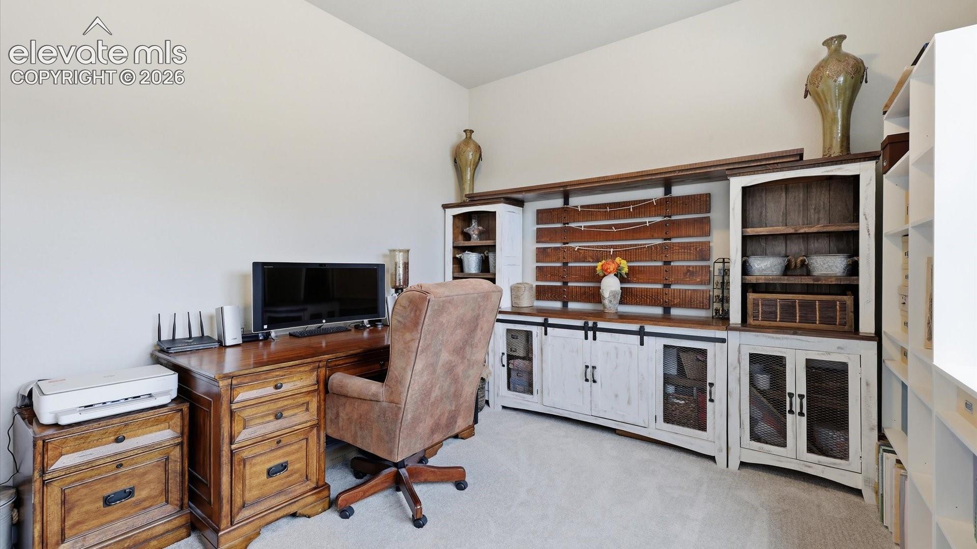 A PRIVATE GUEST RETREAT — Generously sized and ideally situated away from the primary suite, this main-level bedroom provides a peaceful and welcoming space for guests.