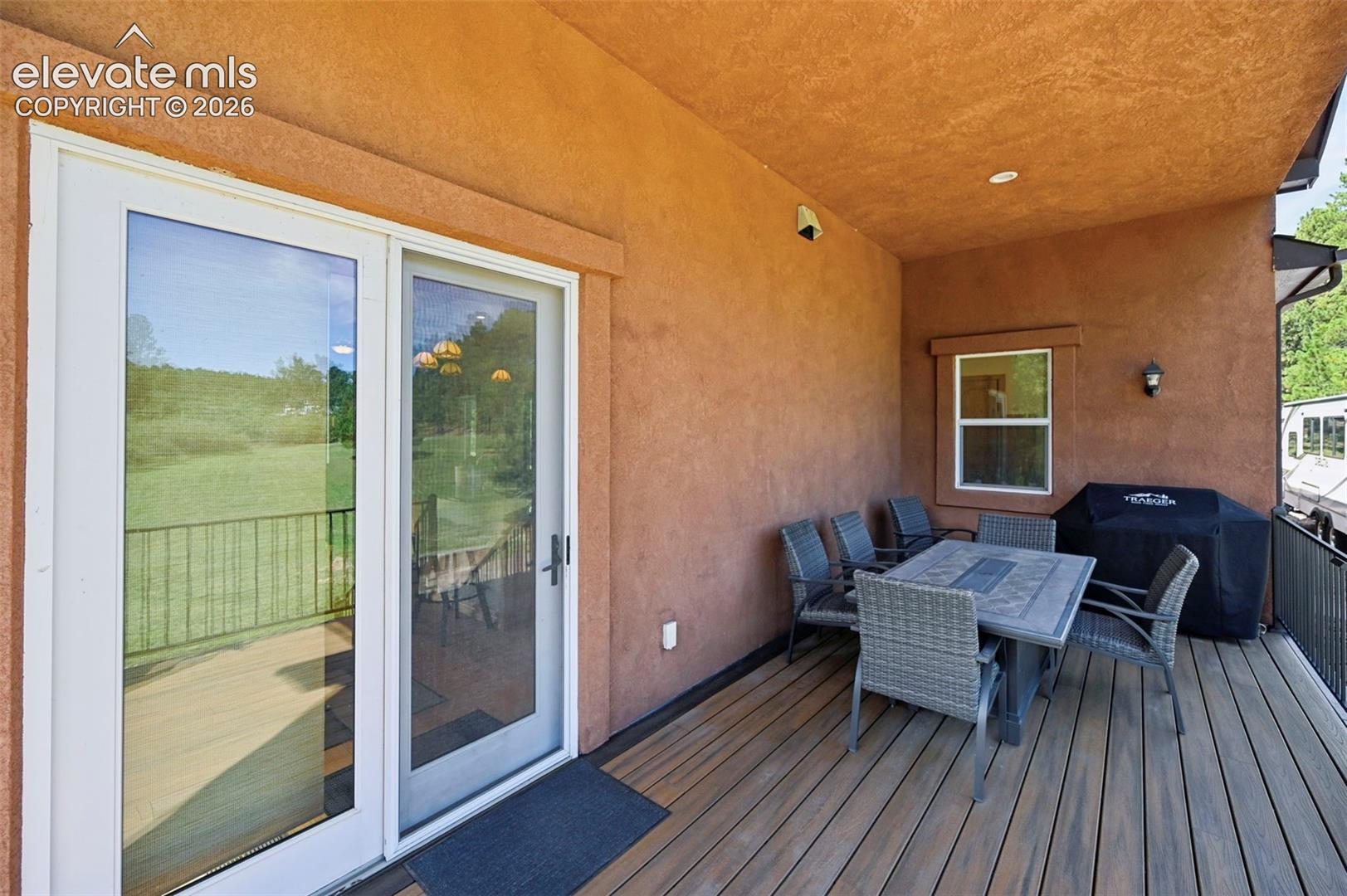 Covered porch off kitchen dining area - perfect for grilling and dining!