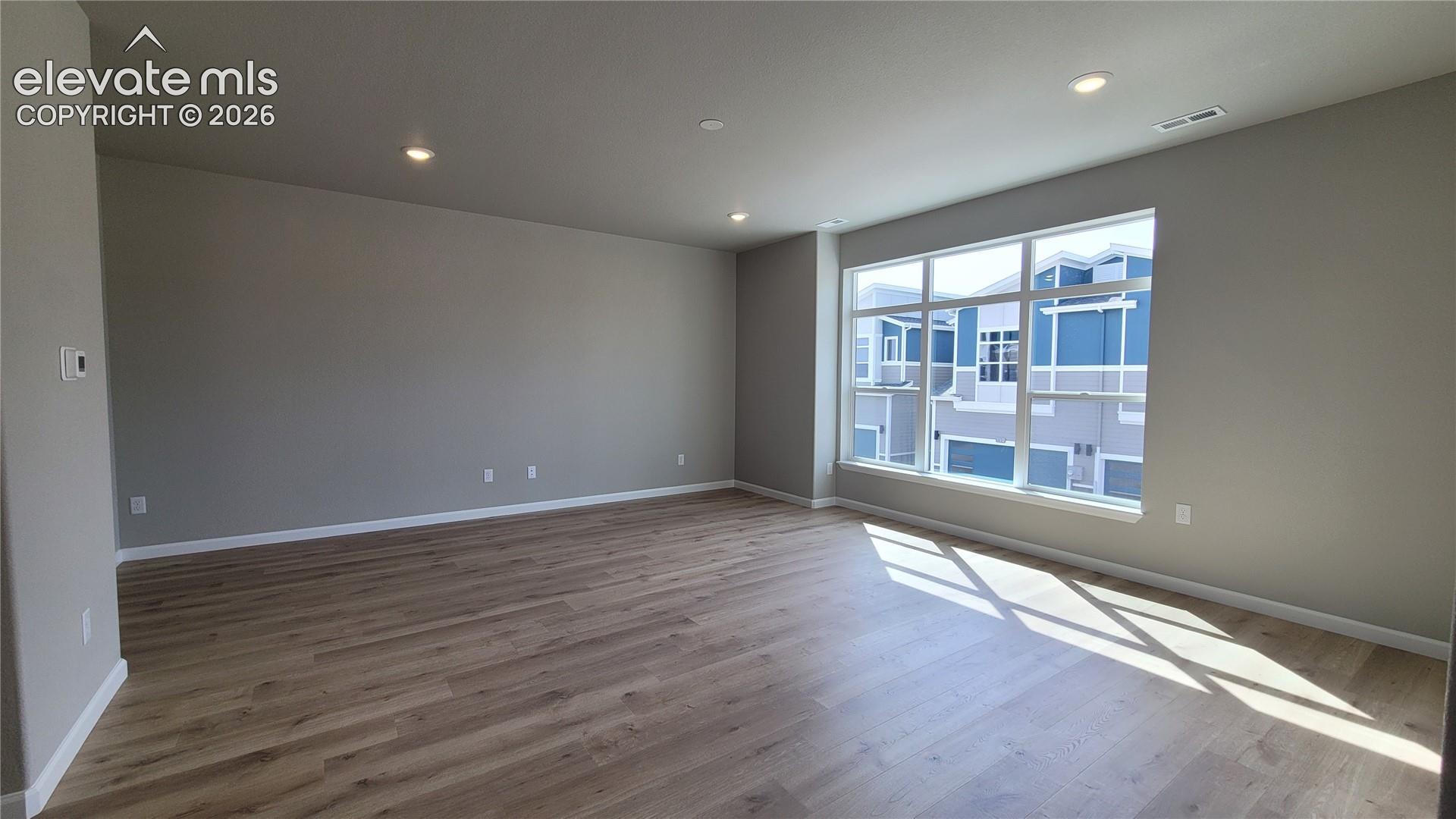 Spacious Living Room with LVP flooring, abundance of natural light, walks out to composite deck! 