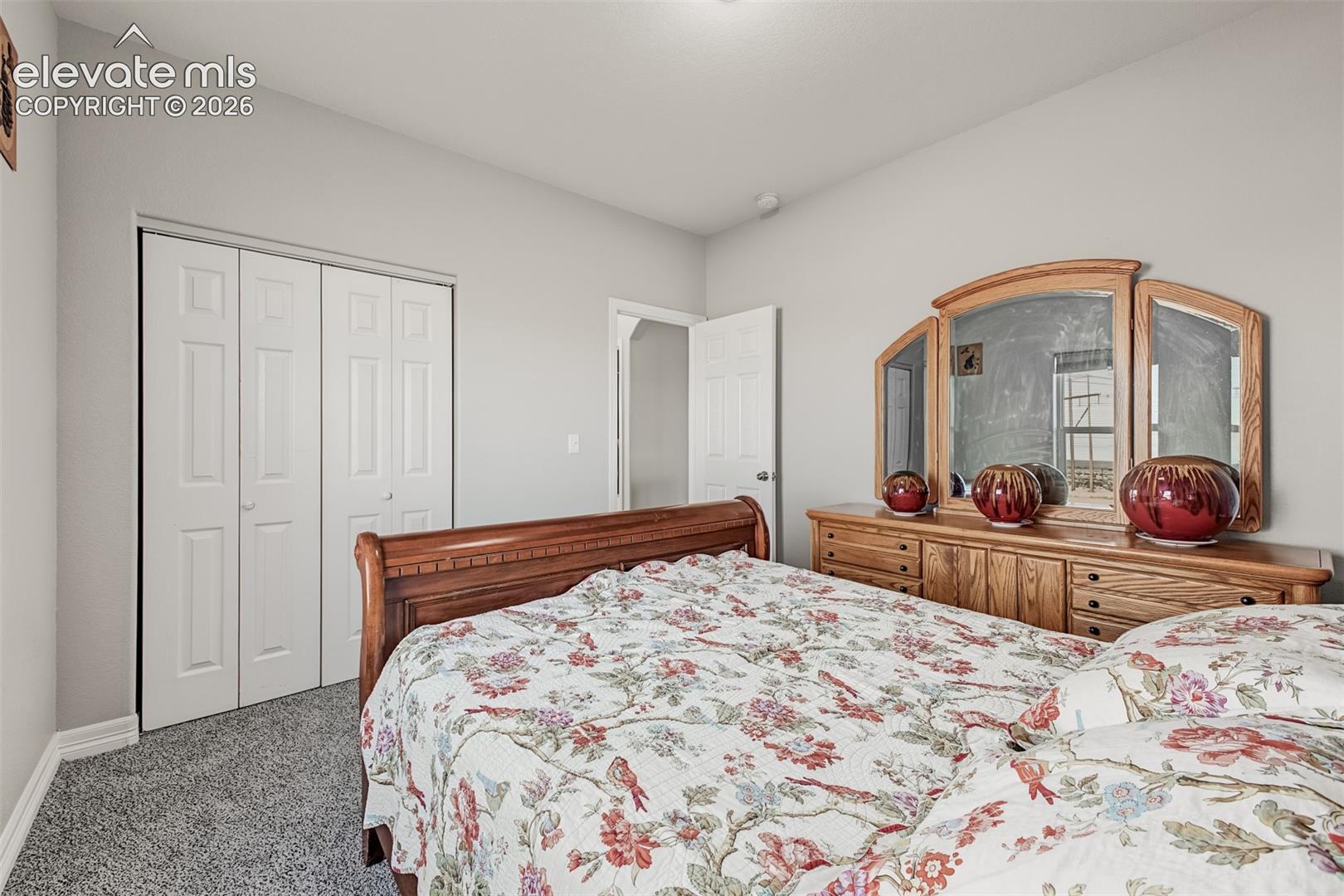 Guest bedroom with new carpet and plenty of closet space.