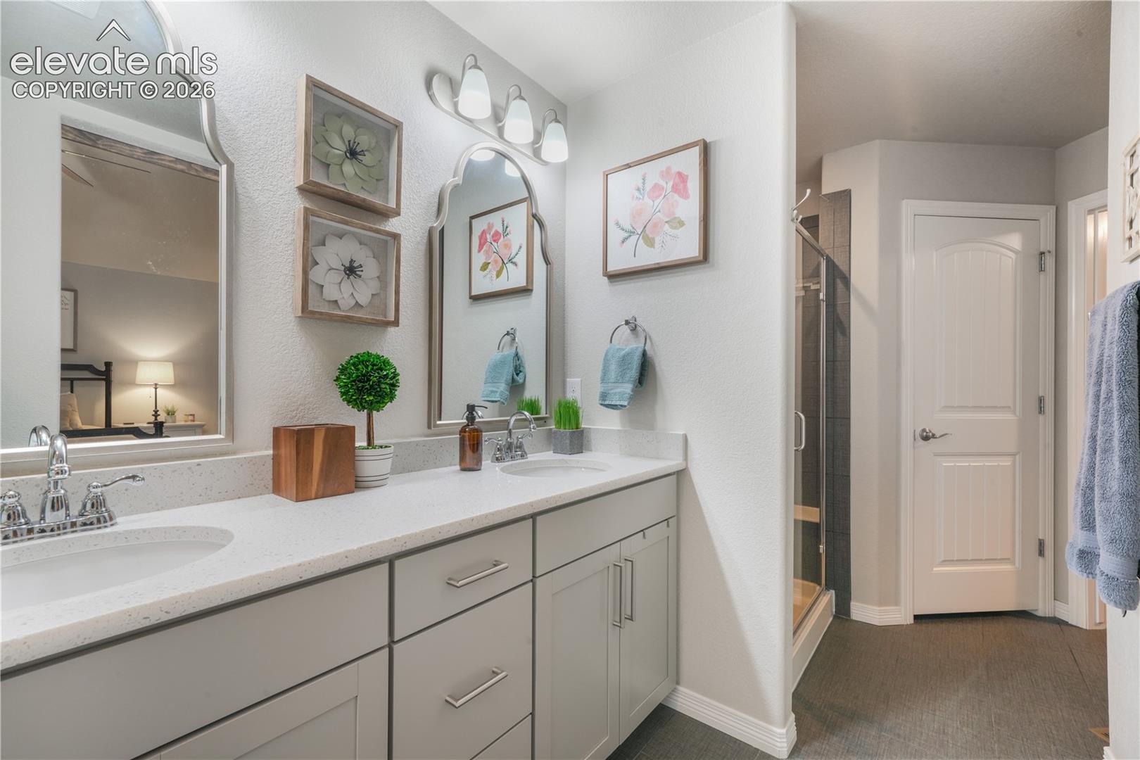 Dual vanity with light-toned countertops and undermount sinks