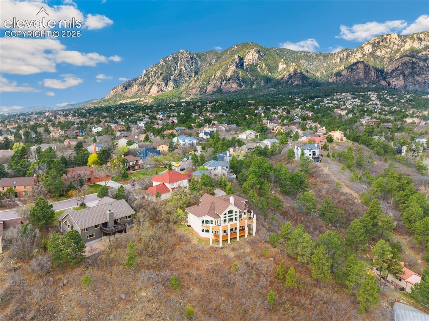 Expansive mountain residential area featuring numerous homes nestled among mature trees and natural landscaping