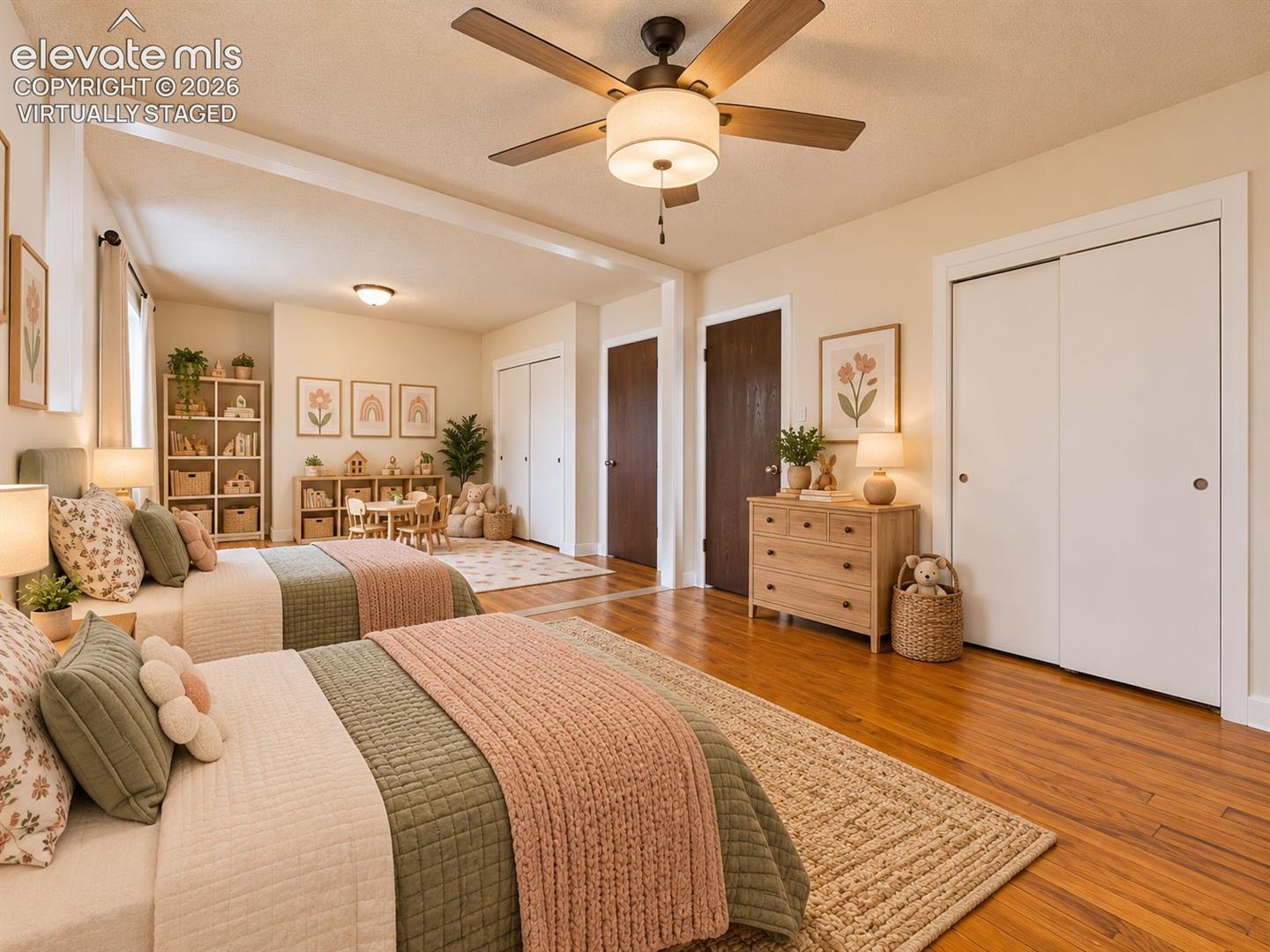 (Virtually Staged)
Versatile expanded bedroom envisioned with two beds and a dedicated children's play area, highlighting the room's generous dimensions and flexible layout.