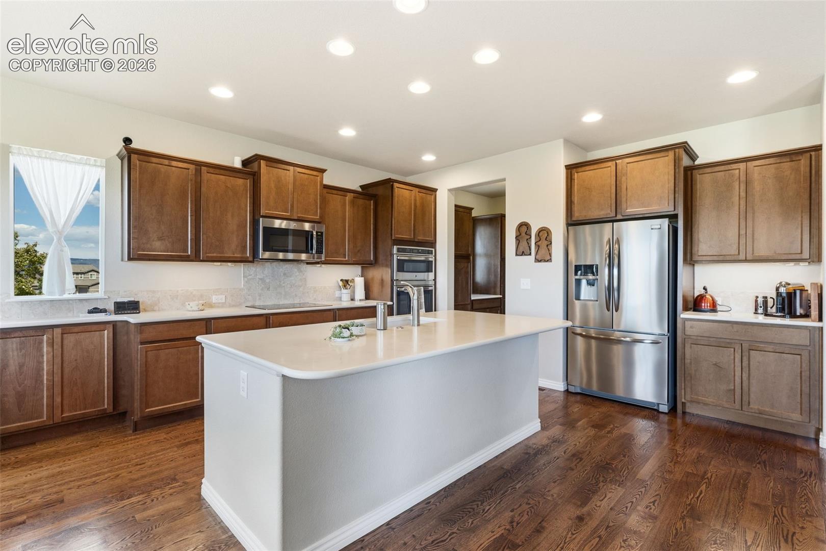 Kitchen featuring stainless appliances, butler's pantry, and quartz countertops