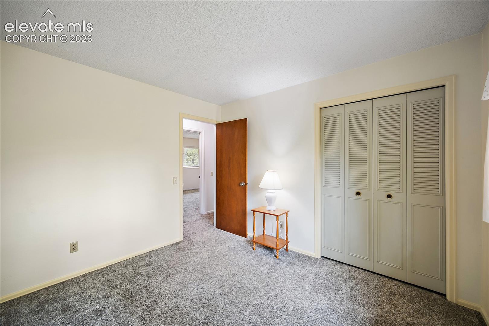 Upstairs bedroom with carpet and good sized closet