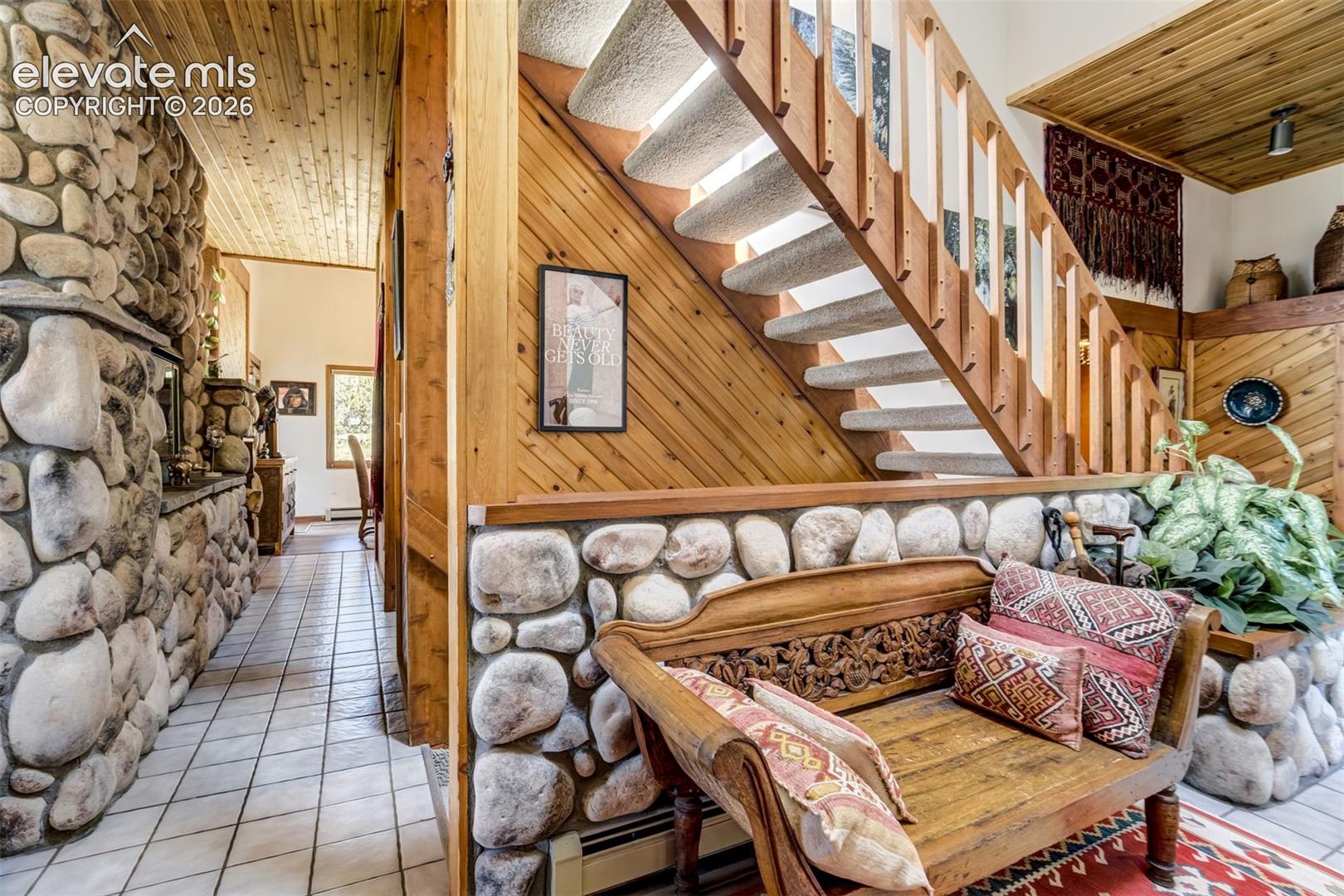 Stairs to the loft by the entrance. There are 5 different river rock planters with faux plants included. Ask about a list of furniture for sale