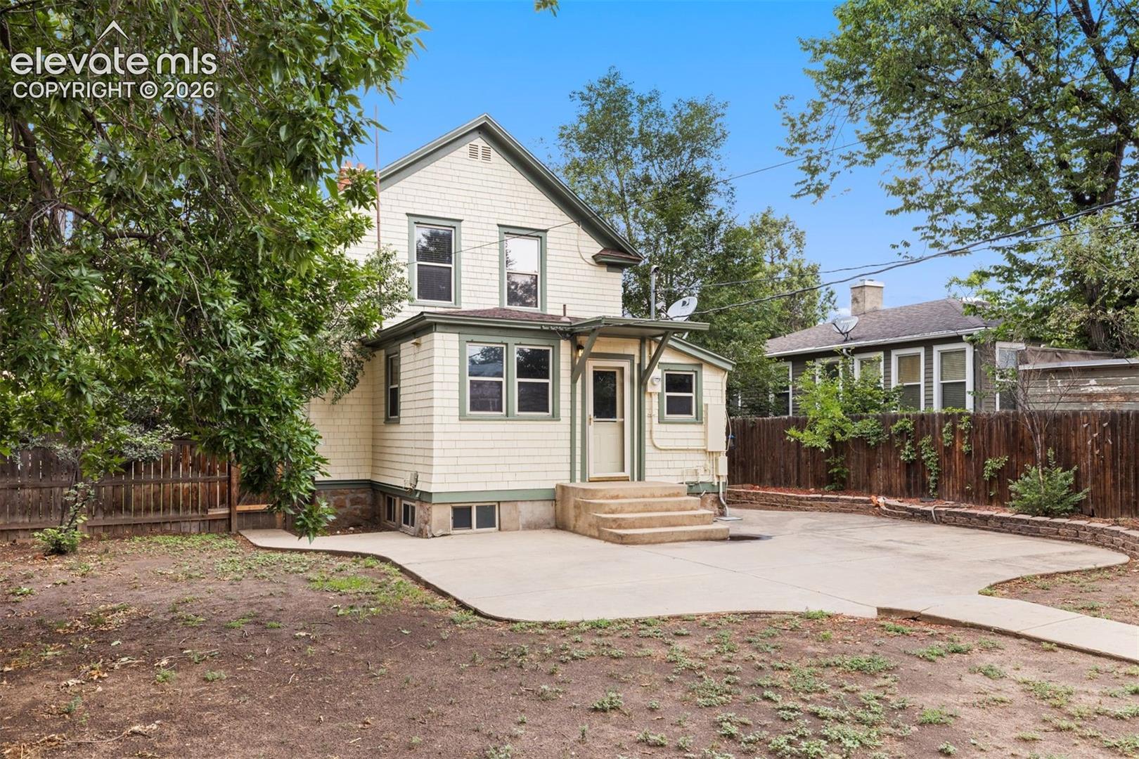 Back of home with large patio