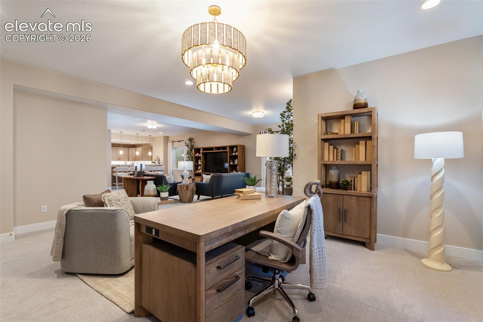 Multi-tiered drum chandelier with decorative metallic finish, neutral carpet flooring, and recessed ceiling lighting