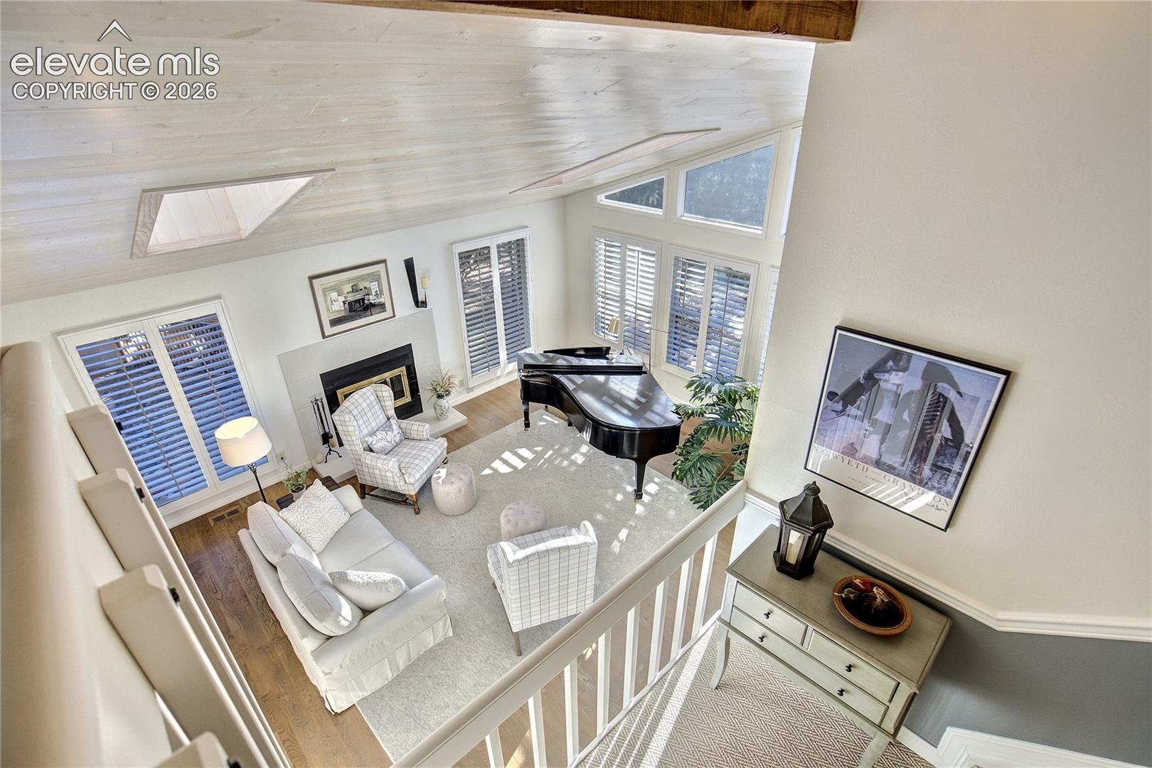 From above, the home's remarkable scale comes into focus as the loft overlooks the light-filled living spaces below.