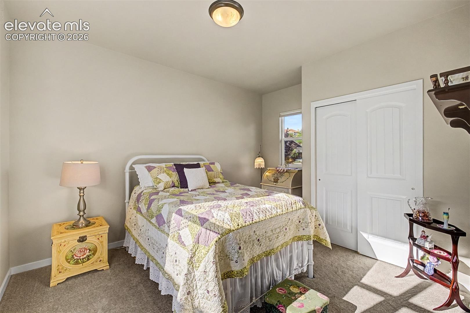 Private secondary main-level bedroom conveniently located adjacent to a full bath, offering comfort and privacy for guests.