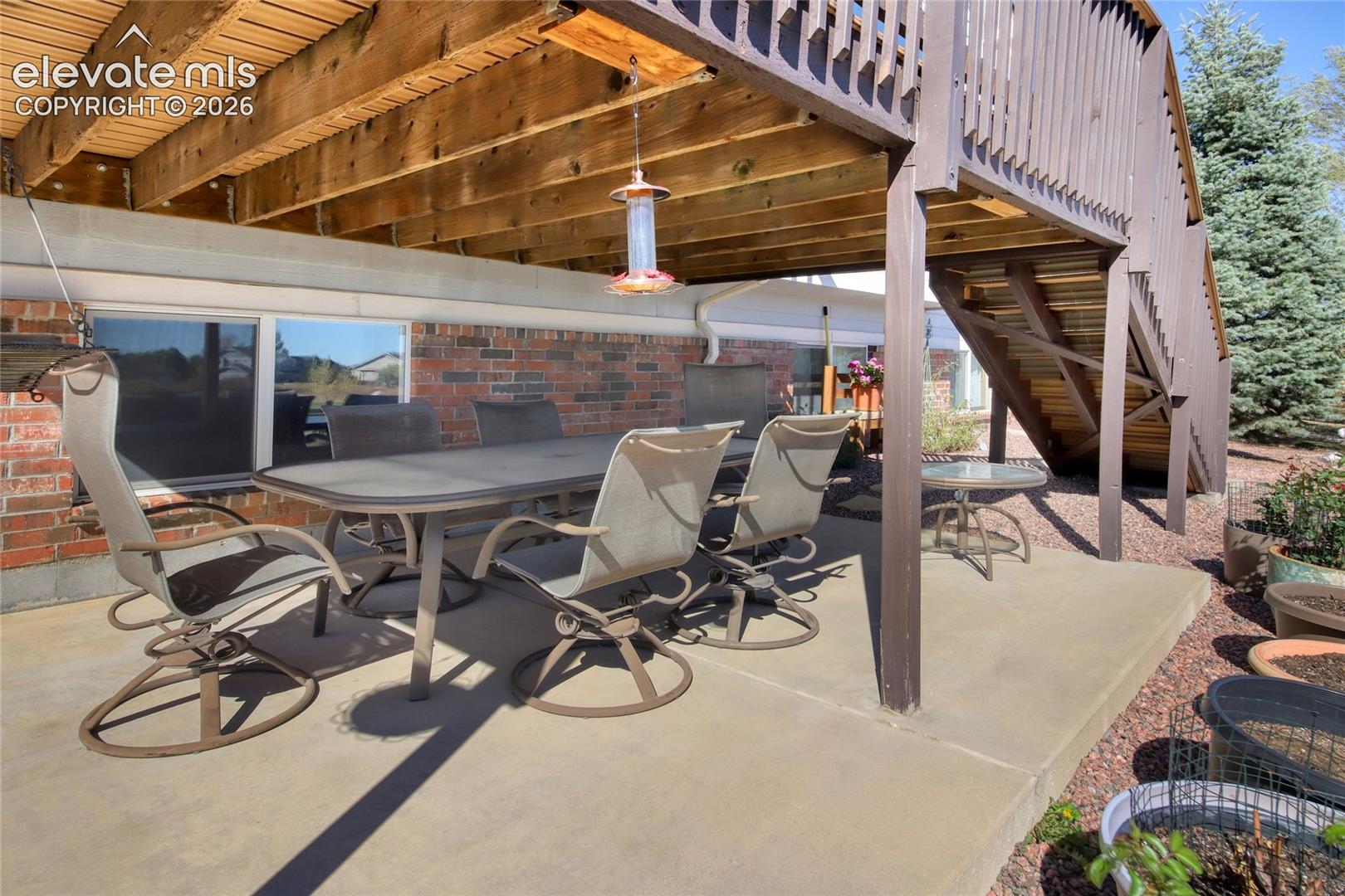 Covered concrete patio under main trex deck