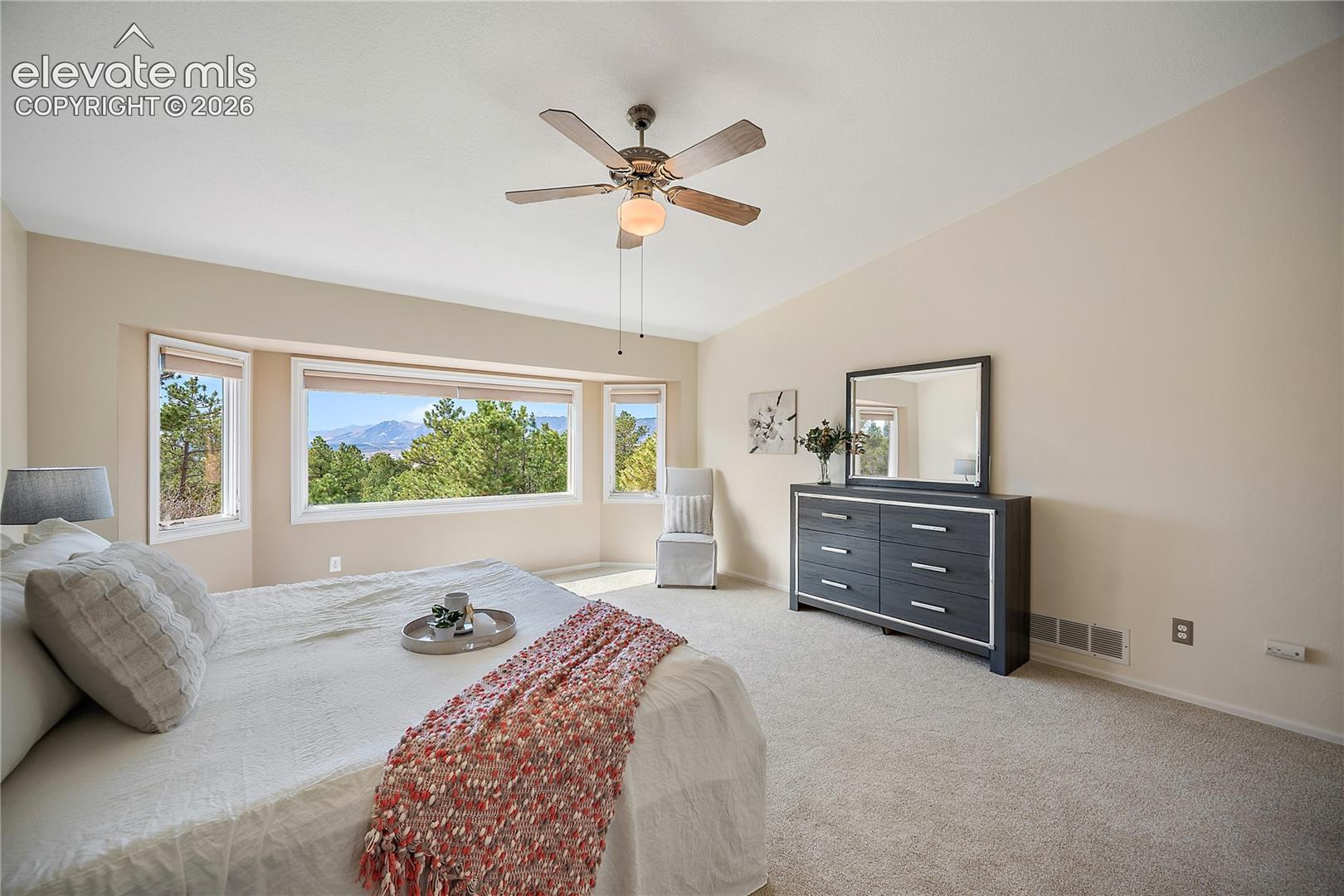 Upstairs primary suite with vaulted ceilings and stunning mountain views. 