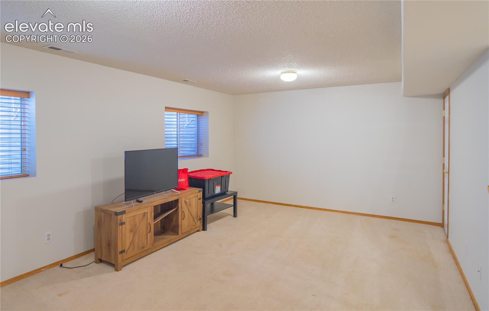 Finished basement family room offers flexible space for movie nights, games, or a relaxing retreat.