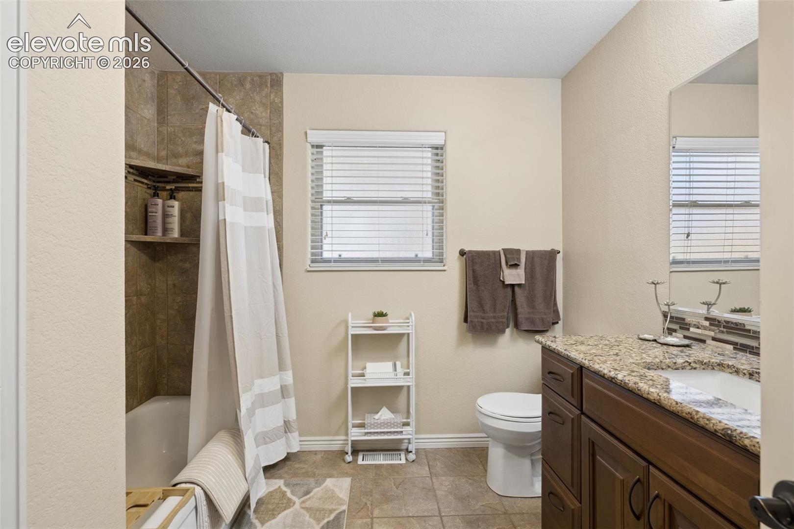 Full guest bathroom on the main level with granite countertop