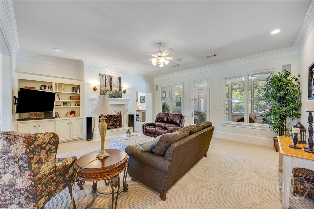 Family room gathering area with fireplace and view