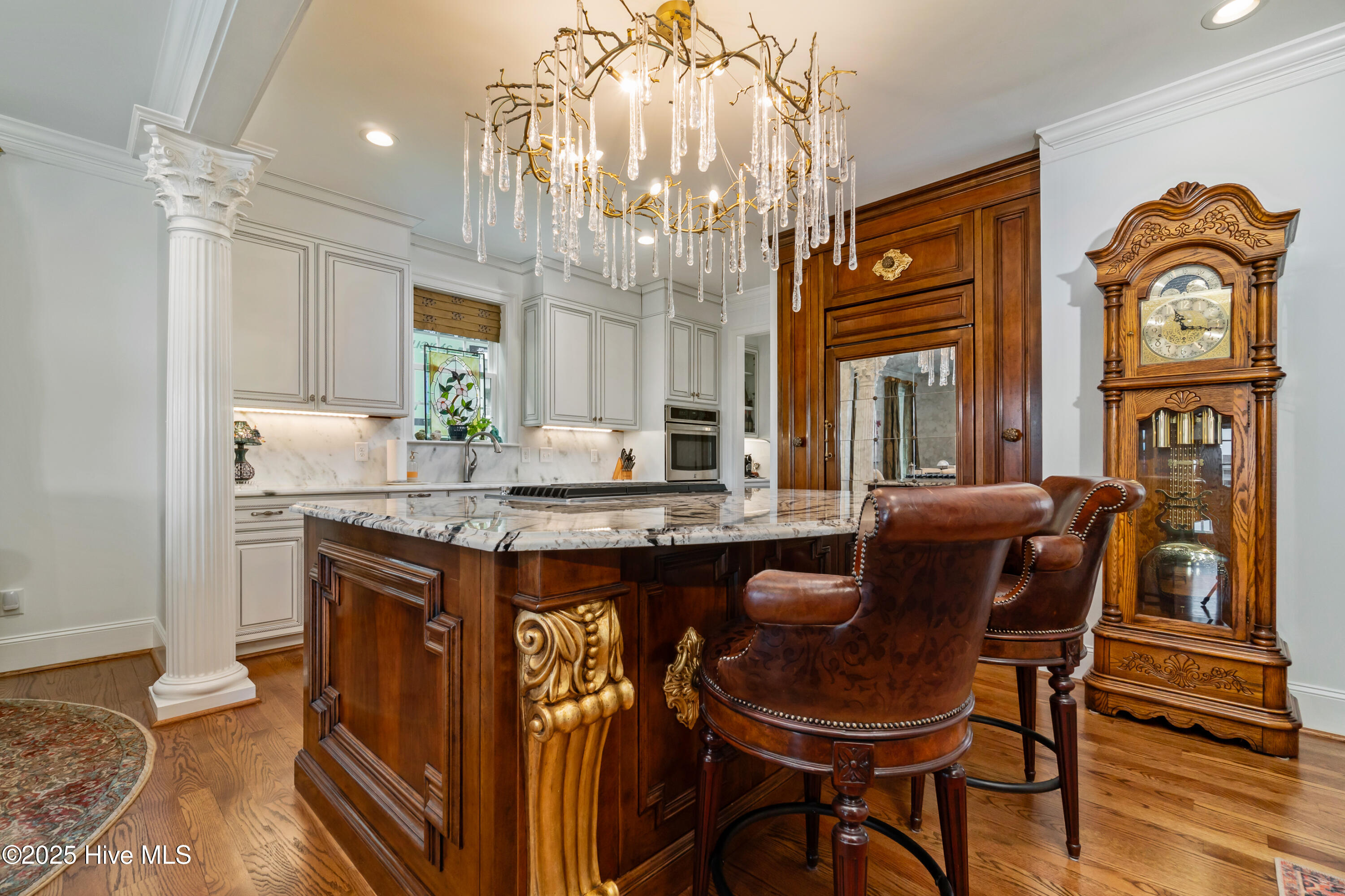 incredible chandelier is the centerpiece to this chef's kitchen