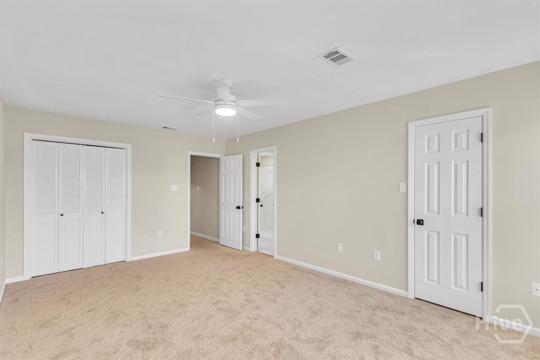 Back bedroom with new carpet and ceiling fan