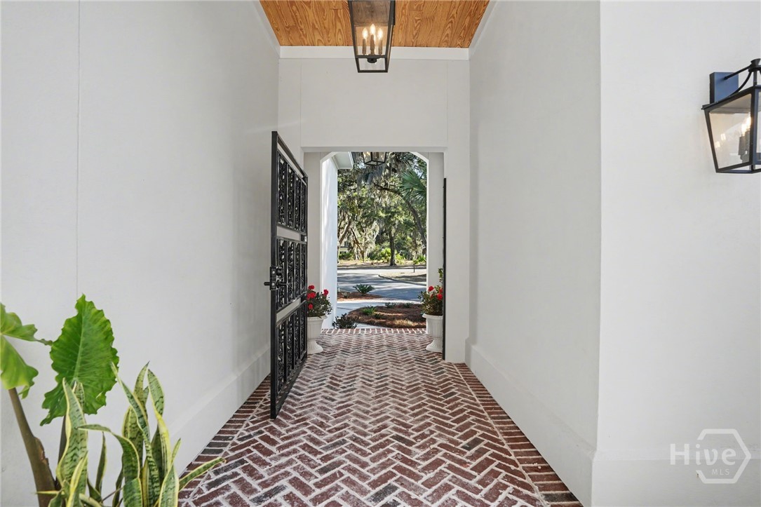 Enter the iron gate into the brick courtyard that separates the main part of the home from the main level guest suite.