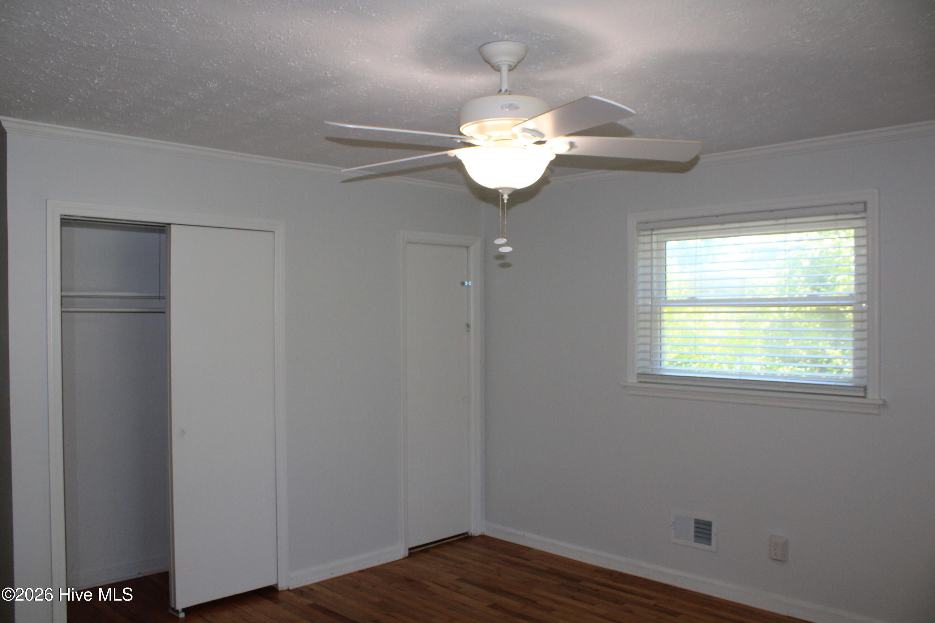 Original hardwood floors, Ceiling fan and rear patio access.