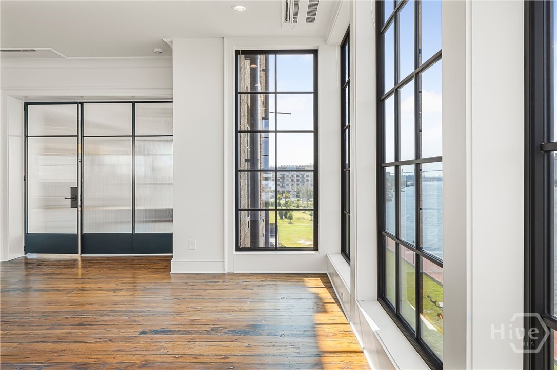 Primary suite with floor to ceiling windows.